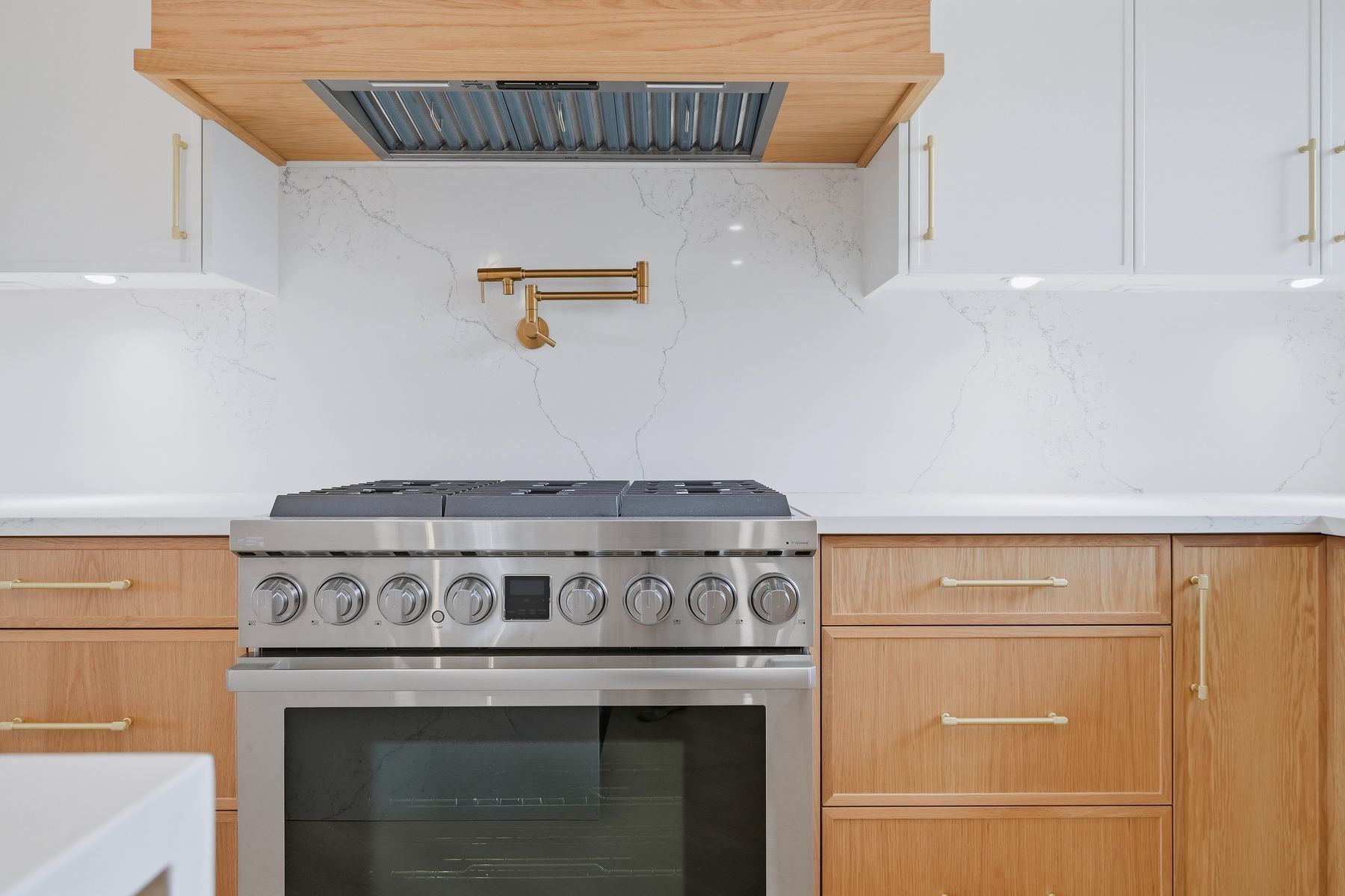 Range and brass pot-filler — detail